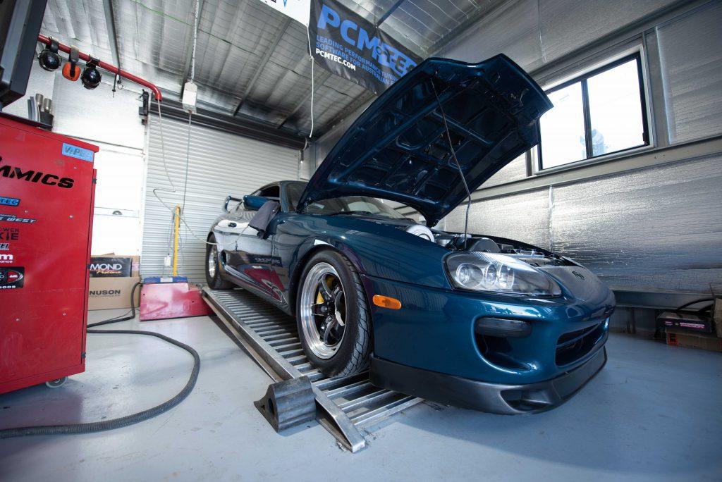 Car strapped onto the dyno with its bonnet up