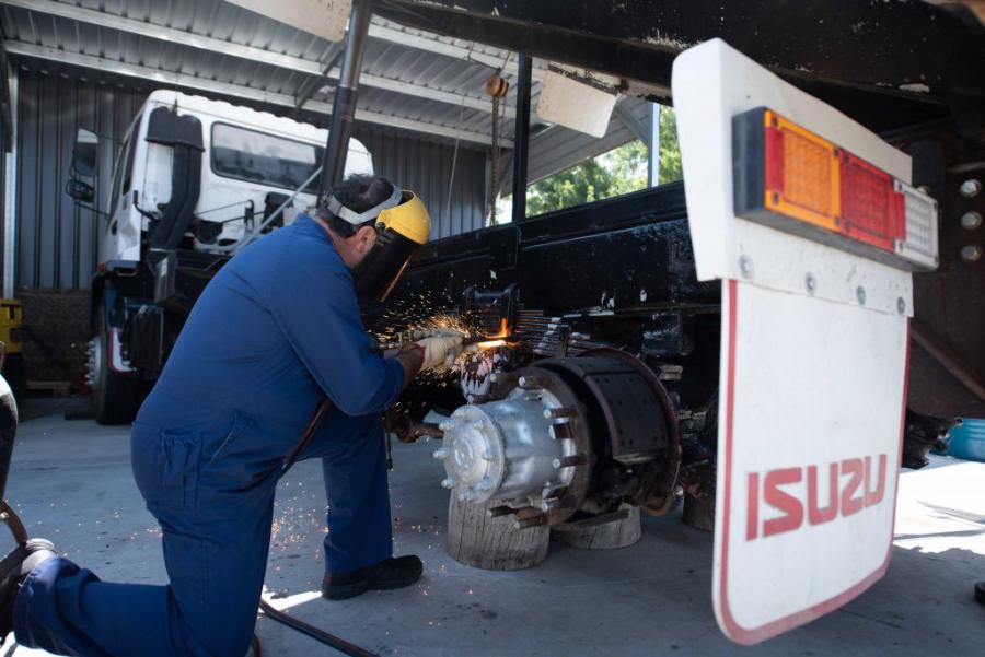 Mechanic working on a truck's rear brakes