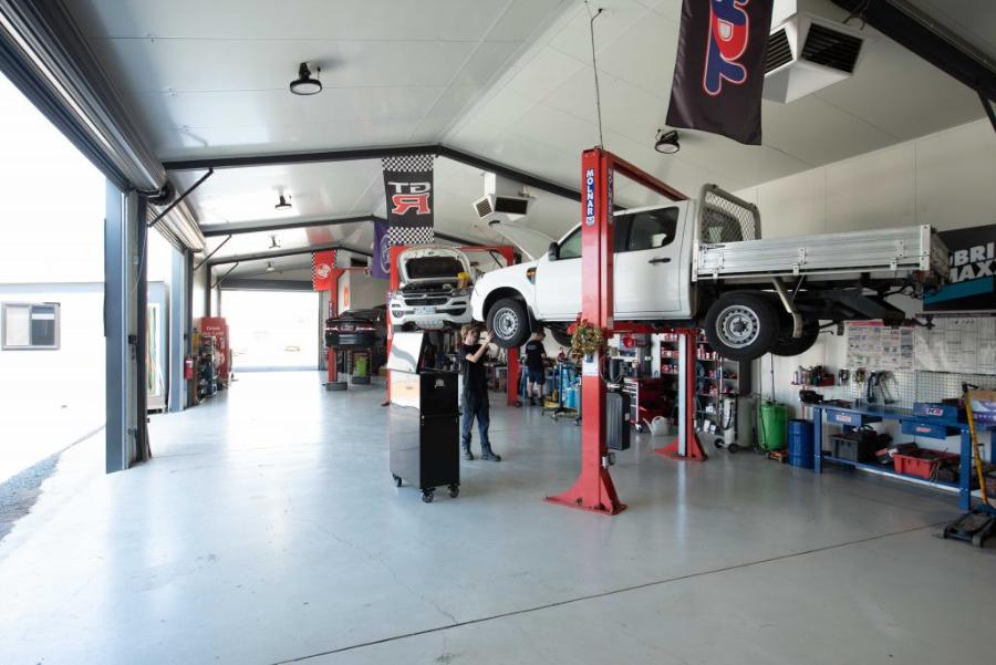 Inside the workshop with a ute on the hoist