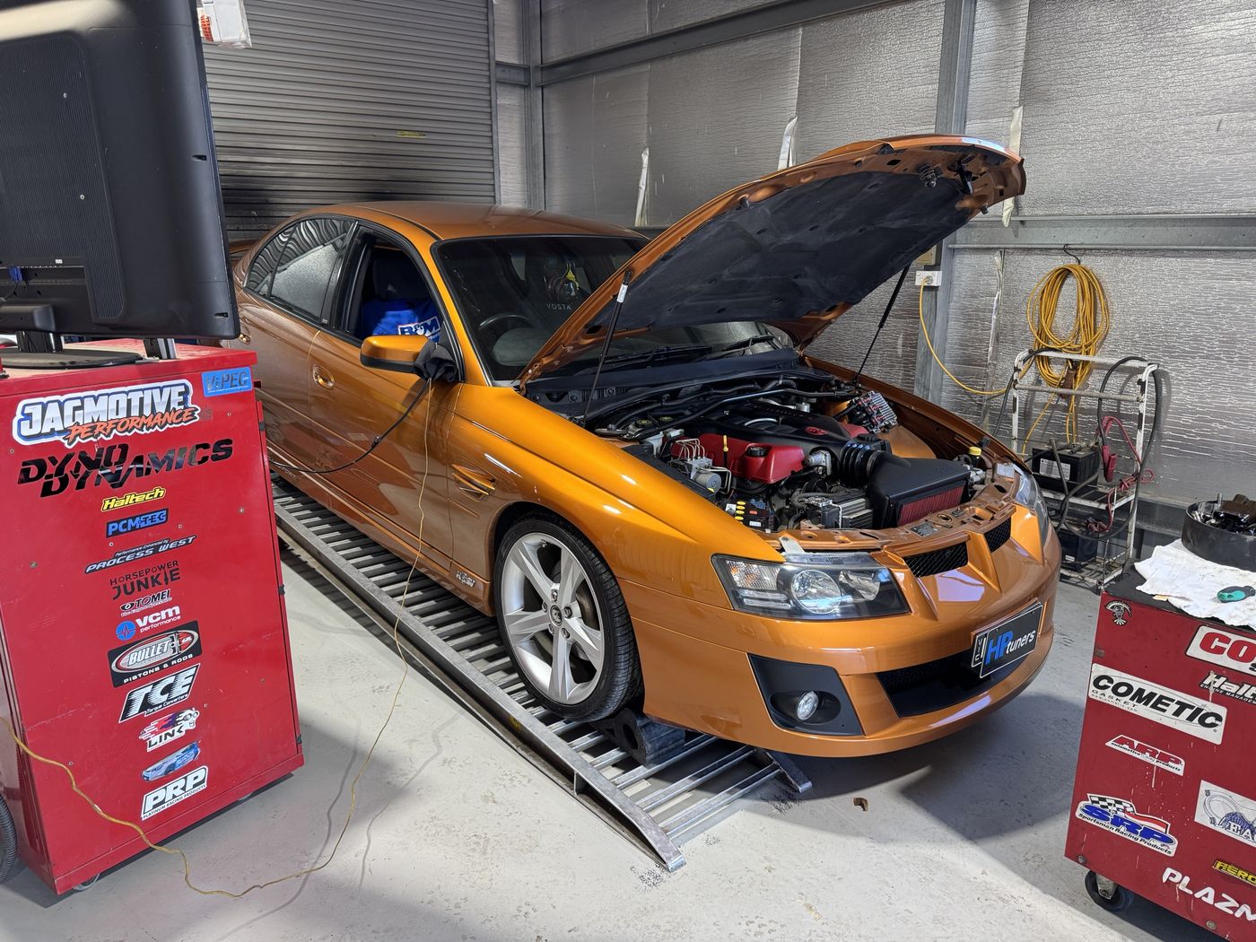 Orange HSV VZ Clubsport on the Jagmotive dyno with its bonnet up