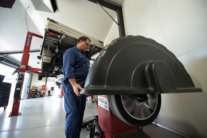 Mechanic balancing a wheel